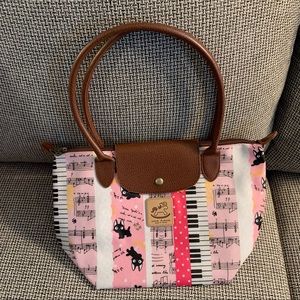 Uma Hana waterproof bag with zip top and also flap snap closure